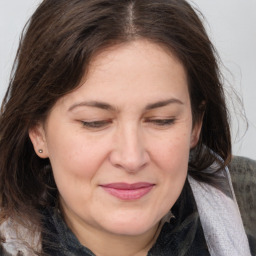 Joyful white adult female with medium  brown hair and brown eyes