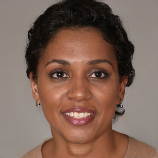 Joyful black young-adult female with short  brown hair and brown eyes