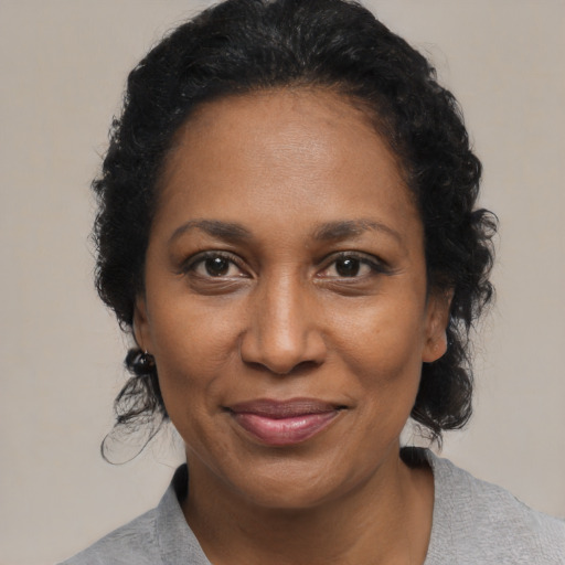 Joyful black adult female with medium  black hair and brown eyes