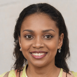 Joyful black young-adult female with medium  brown hair and brown eyes