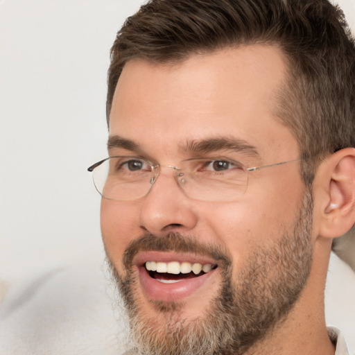 Joyful white adult male with short  brown hair and brown eyes