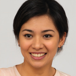 Joyful asian young-adult female with medium  brown hair and brown eyes