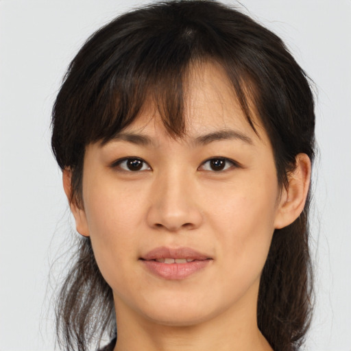Joyful asian young-adult female with medium  brown hair and brown eyes