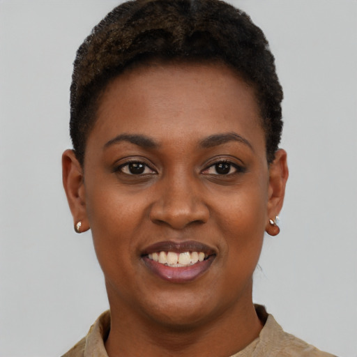 Joyful black young-adult female with short  black hair and brown eyes