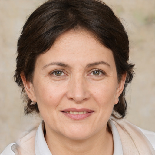 Joyful white adult female with medium  brown hair and brown eyes