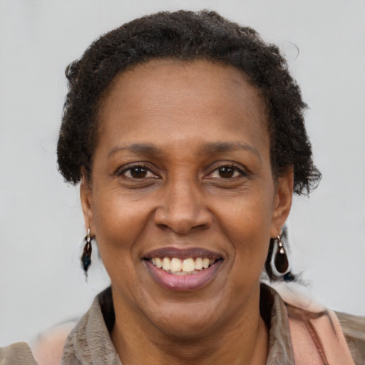 Joyful black adult female with short  brown hair and brown eyes