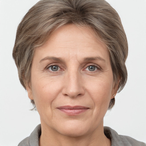 Joyful white adult female with medium  brown hair and grey eyes