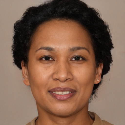Joyful latino adult female with short  brown hair and brown eyes