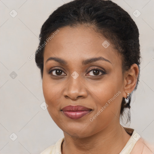 Joyful black young-adult female with short  brown hair and brown eyes