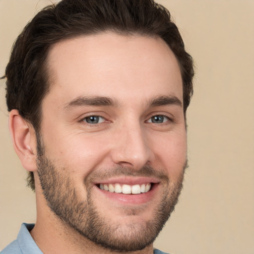 Joyful white young-adult male with short  brown hair and brown eyes