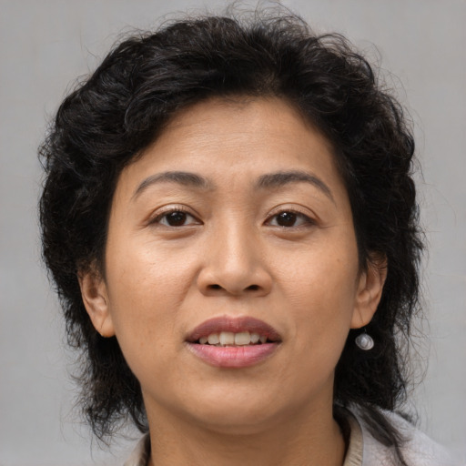 Joyful asian adult female with medium  brown hair and brown eyes