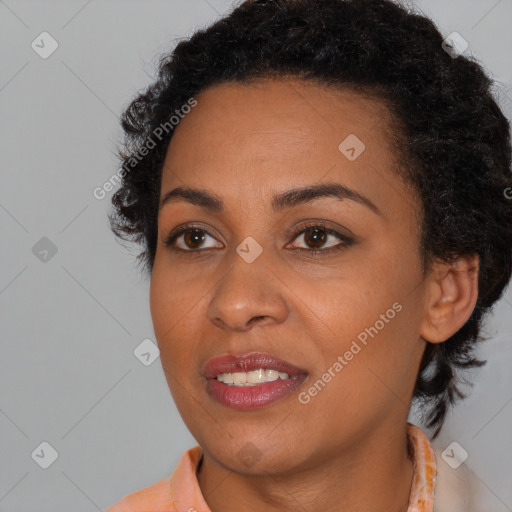 Joyful black young-adult female with short  brown hair and brown eyes