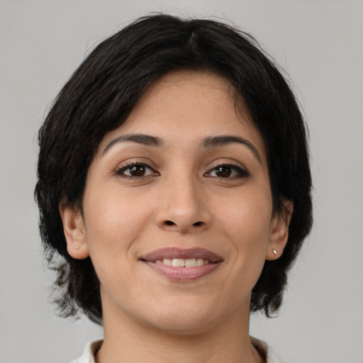 Joyful latino young-adult female with medium  brown hair and brown eyes