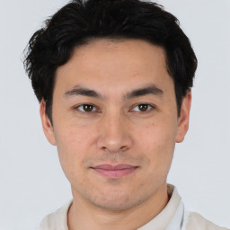 Joyful asian young-adult male with short  black hair and brown eyes