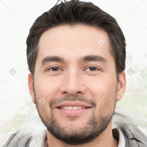 Joyful white young-adult male with short  black hair and brown eyes