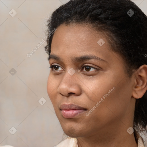 Joyful black young-adult female with short  black hair and brown eyes