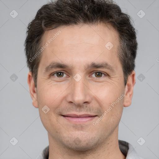 Joyful white adult male with short  brown hair and brown eyes