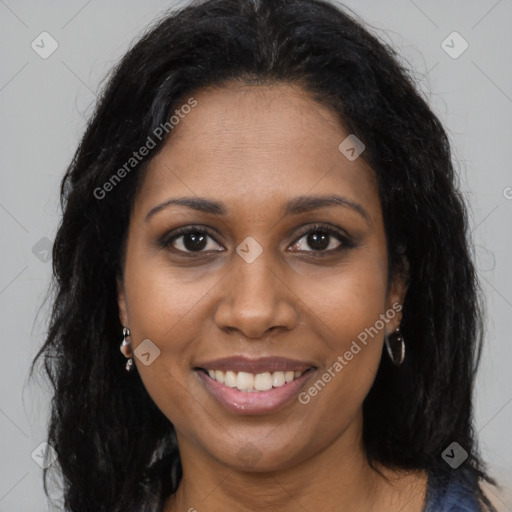 Joyful black young-adult female with long  brown hair and brown eyes