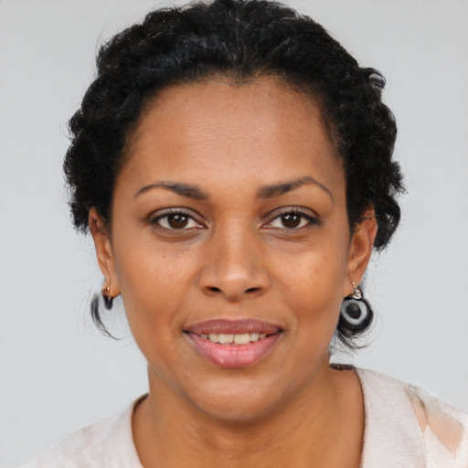 Joyful black young-adult female with medium  brown hair and brown eyes