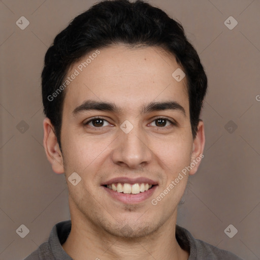 Joyful white young-adult male with short  black hair and brown eyes