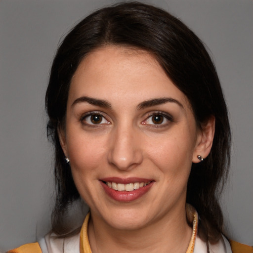 Joyful white young-adult female with medium  brown hair and brown eyes