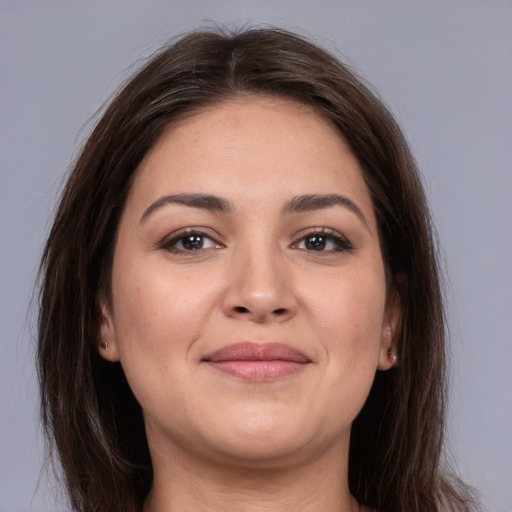 Joyful white young-adult female with long  brown hair and brown eyes