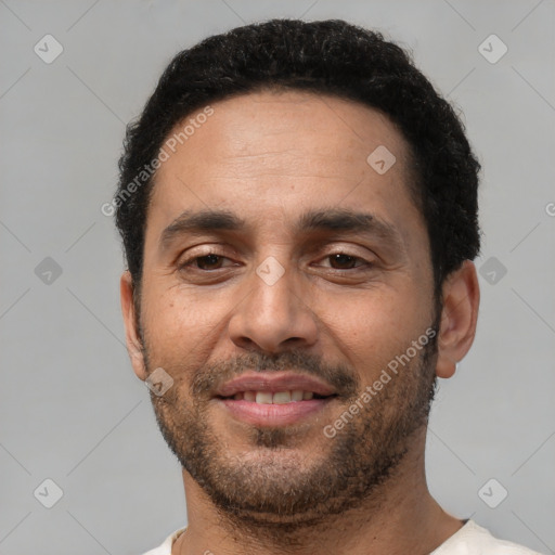 Joyful white adult male with short  black hair and brown eyes