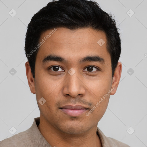 Joyful latino young-adult male with short  black hair and brown eyes