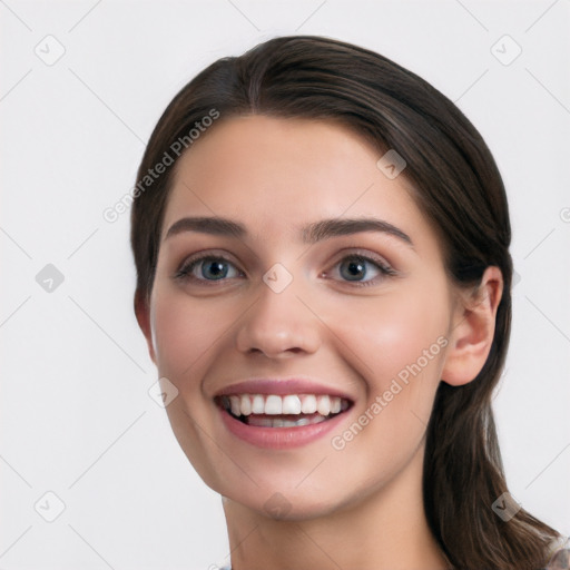 Joyful white young-adult female with long  black hair and brown eyes