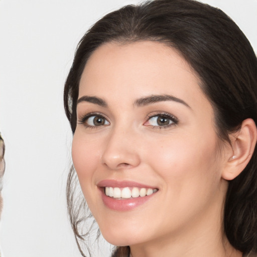 Joyful white young-adult female with medium  brown hair and brown eyes