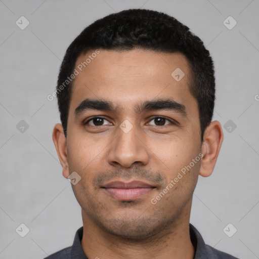 Joyful latino young-adult male with short  black hair and brown eyes