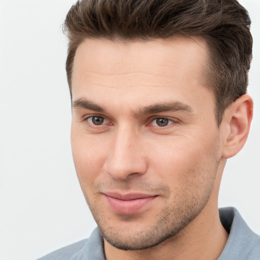 Joyful white young-adult male with short  brown hair and brown eyes