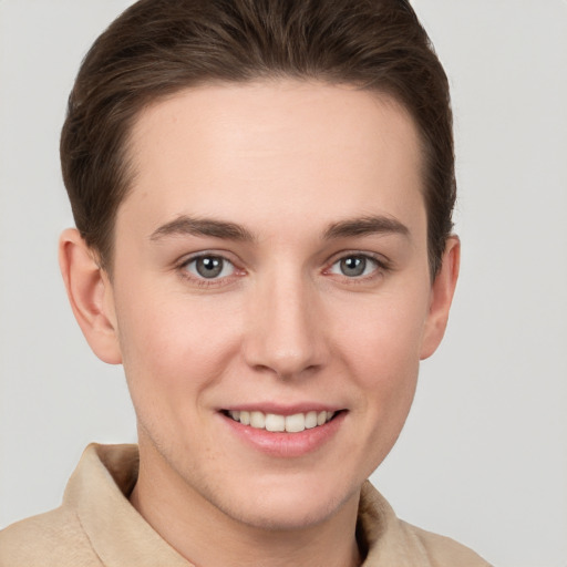 Joyful white young-adult female with short  brown hair and grey eyes