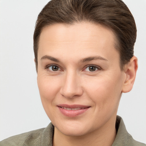 Joyful white young-adult female with short  brown hair and grey eyes