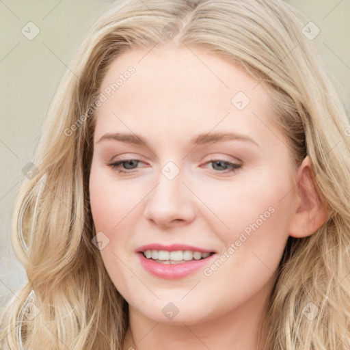 Joyful white young-adult female with long  brown hair and blue eyes