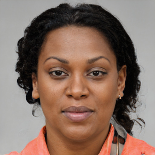Joyful black adult female with medium  brown hair and brown eyes