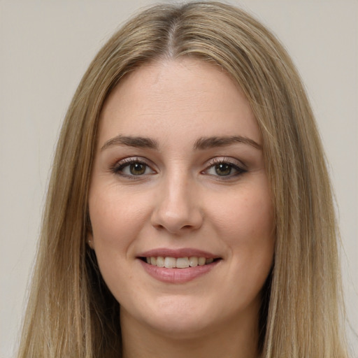 Joyful white young-adult female with long  brown hair and green eyes