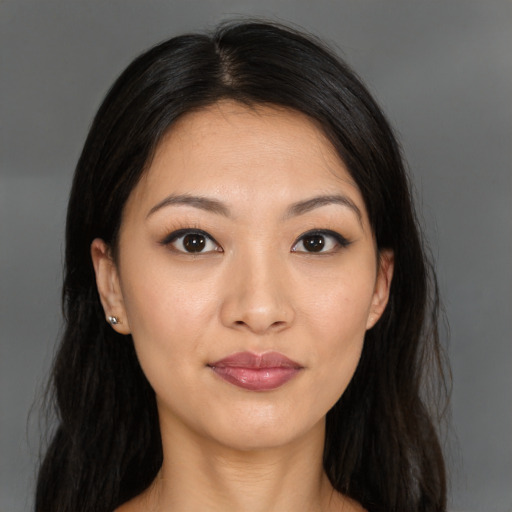 Joyful asian young-adult female with long  brown hair and brown eyes