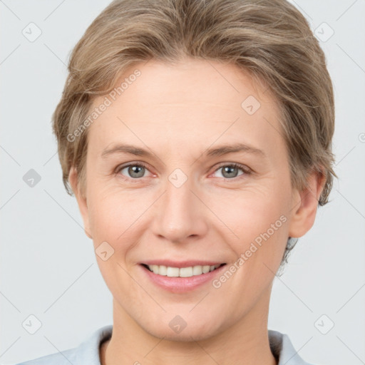 Joyful white young-adult female with short  brown hair and grey eyes