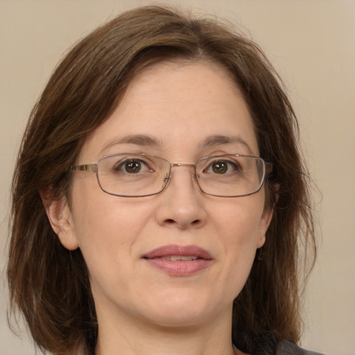 Joyful white adult female with medium  brown hair and brown eyes