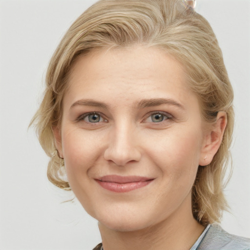 Joyful white young-adult female with medium  brown hair and blue eyes