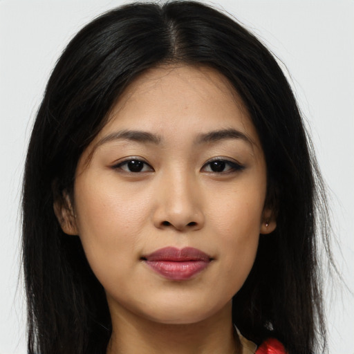 Joyful asian young-adult female with long  brown hair and brown eyes