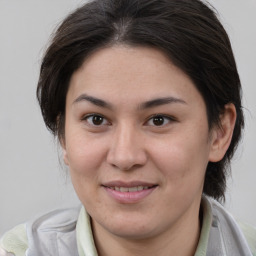 Joyful white young-adult female with medium  brown hair and brown eyes