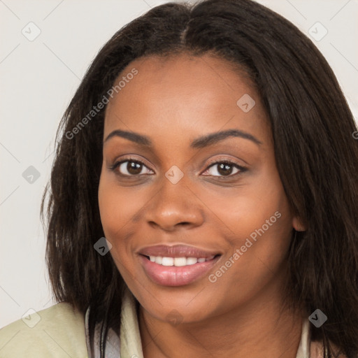 Joyful black young-adult female with long  brown hair and brown eyes