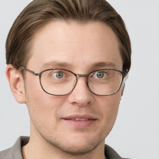 Joyful white adult male with short  brown hair and grey eyes