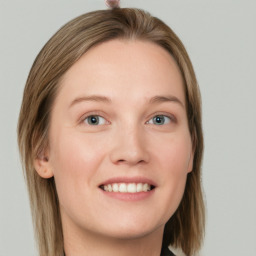 Joyful white young-adult female with long  brown hair and blue eyes