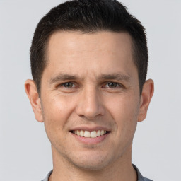 Joyful white young-adult male with short  brown hair and brown eyes