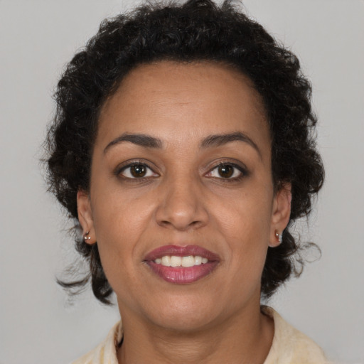 Joyful latino adult female with short  brown hair and brown eyes