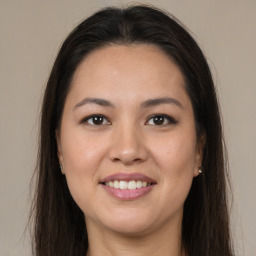 Joyful latino young-adult female with long  brown hair and brown eyes