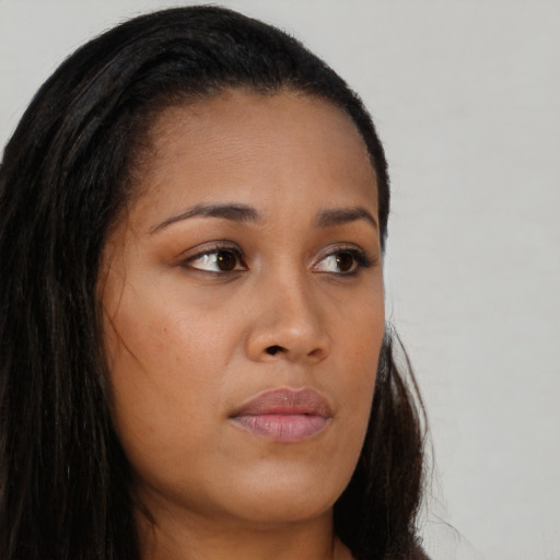 Neutral black young-adult female with long  brown hair and brown eyes